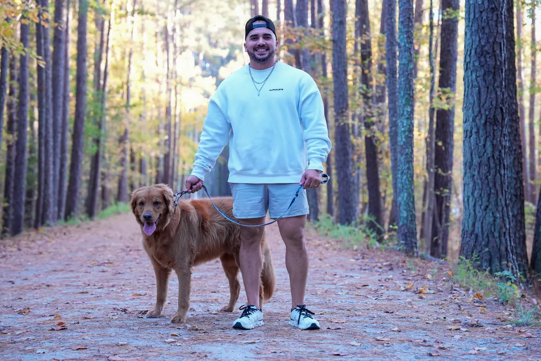 Mario walking Jax down a corridor of tall pines