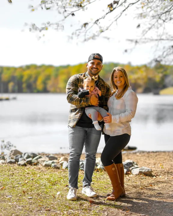 Portrait of Mario, Ashley, and Sloan under an overhanging branch at the lake